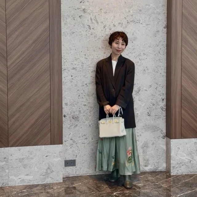 黒ジャケットとグリーンスカートの春のオフ会コーデ、甘すぎない大人フェミニンスタイル